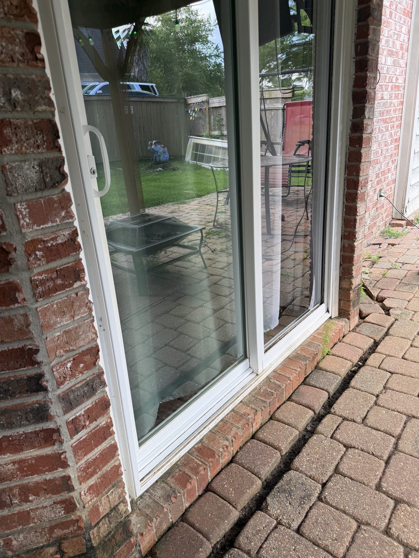 The same sliding glass patio door with clear, streak-free glass after cleaning